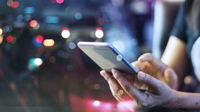 Person tippt mit Finger auf Smartphone