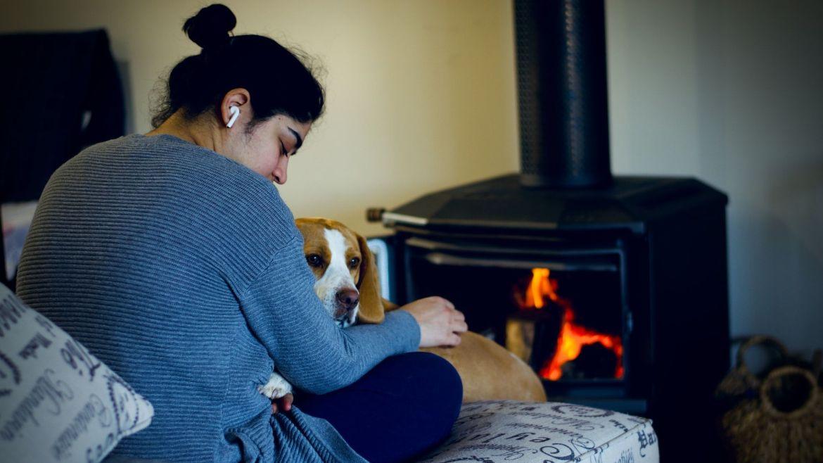 Frau und Hund von Kaminofen