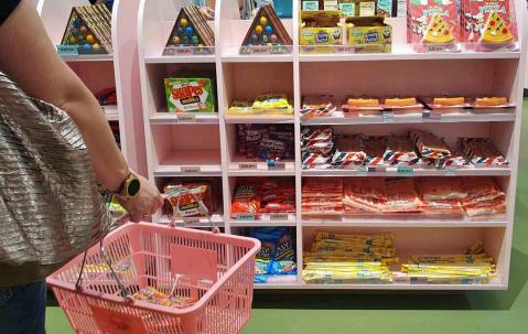 Candy World: Frau mit Einkaufskorb im Laden